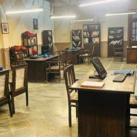 Government office staff area with wooden work desks, chairs and file shelves at Stage 04, Bhajanlal Estate