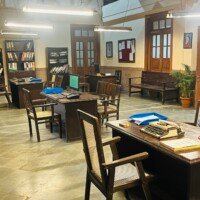 Angled view of government office staff desks with paperwork and filing shelves at Bhajanlal Estate, Kaman
