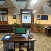 Computer workstation with desk telephone, files and wall portraits in Stage 04 Government Office Set
