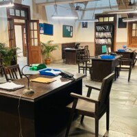 Government office staff workspace with wooden desks, files, windows and shelving at Stage 04, Kaman