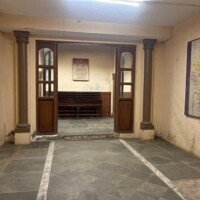 Entry passage of Stage 04 Government Office Set with pillars, double doors and wall-mounted notice board