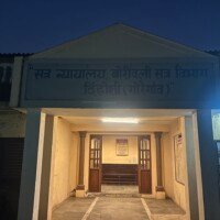 Exterior of Stage 04 Government Office Set with a covered entrance, columns and illuminated sign at Kaman